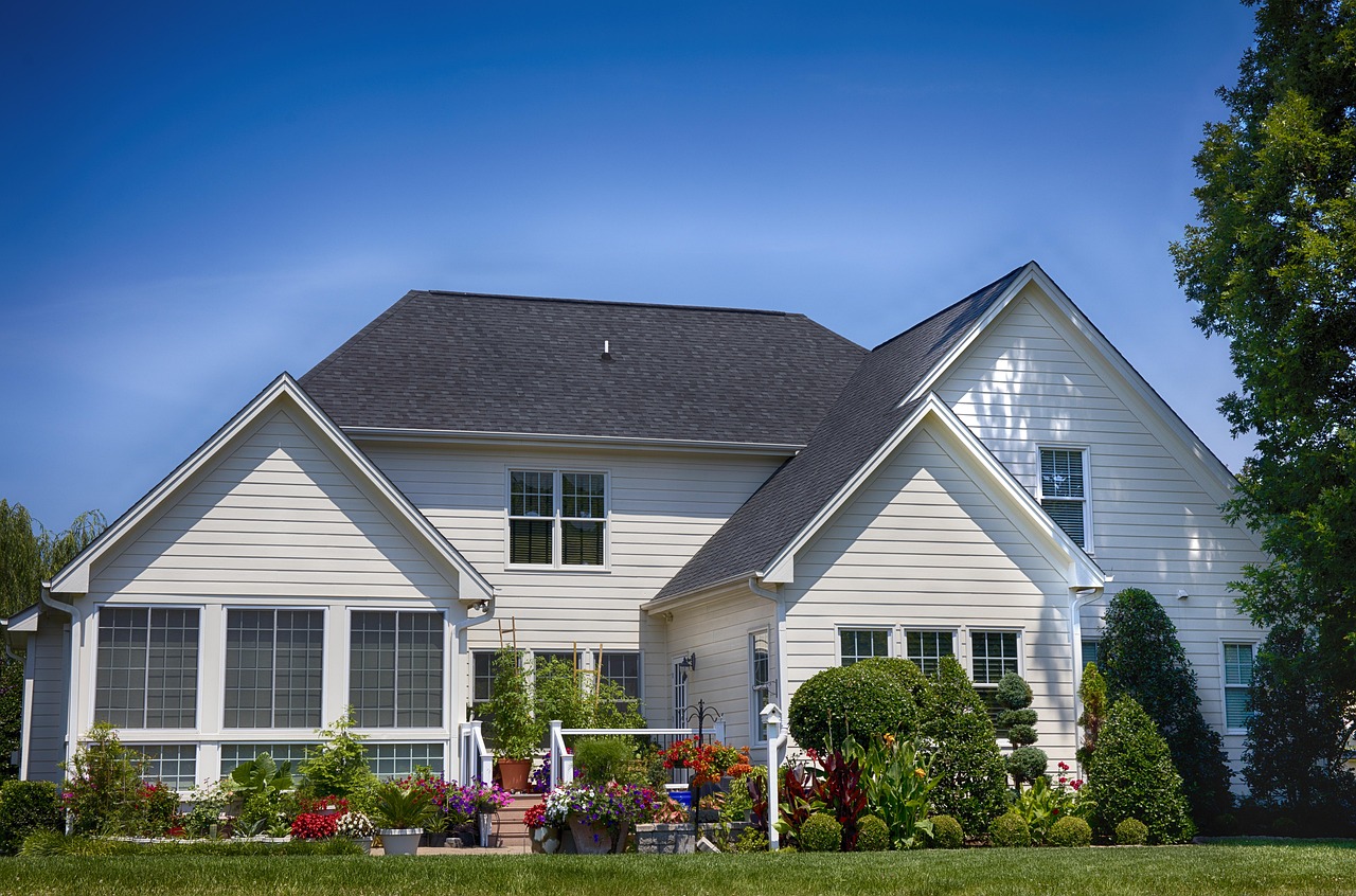 Two-story white house with a landscaped front yard
